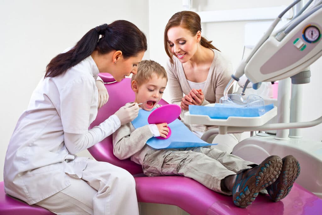 Dentist with child and mother